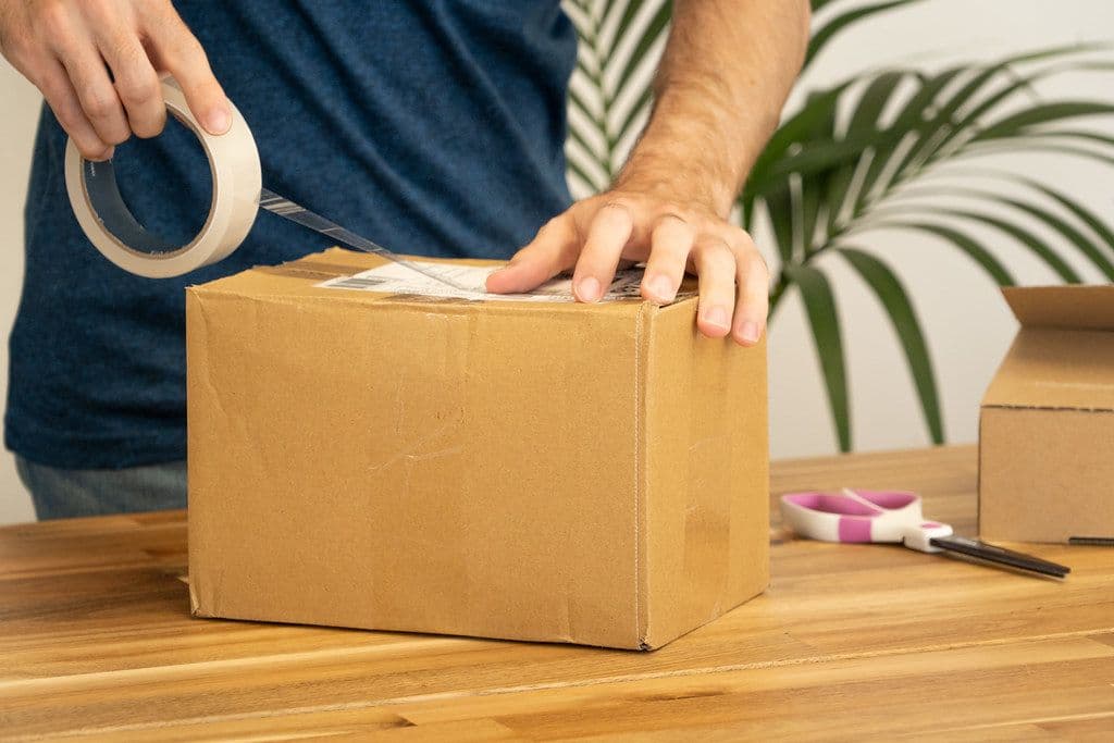 Sticking a label onto a parcel for shipping