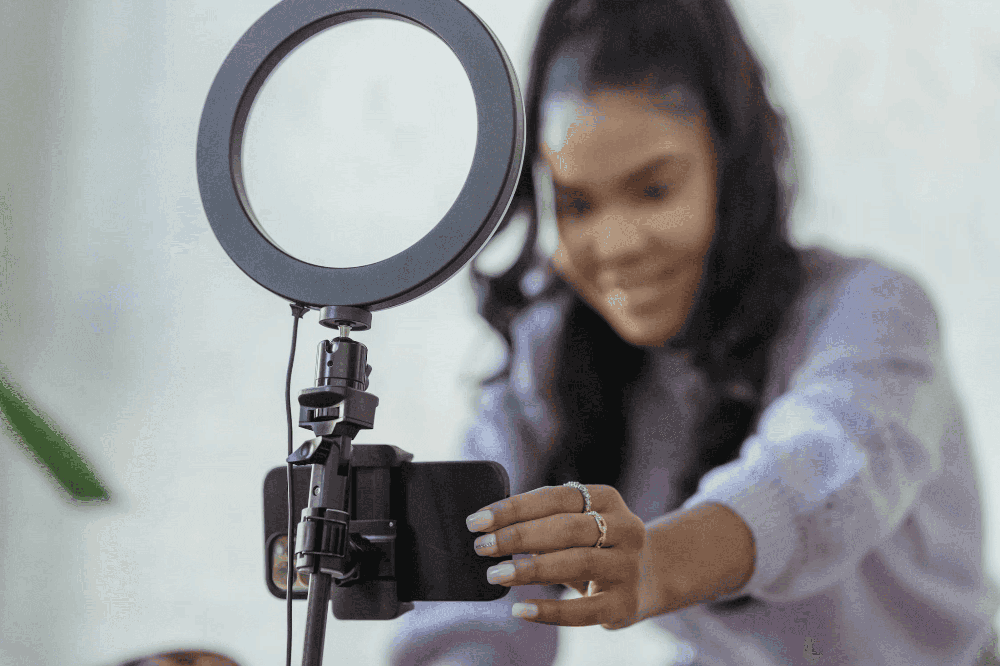 woman-setting-up-smartphone-before-shooting-podcast