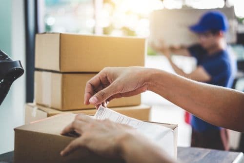 Sticking a label onto a parcel for shipping